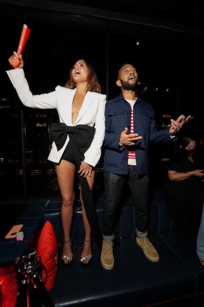 Chrissy Teigen or attended the 2024 JBL Festival at the PHD Rooftop Lounge in New York City in hot pants and a plunging blazer with a massive bow. See her full look here.