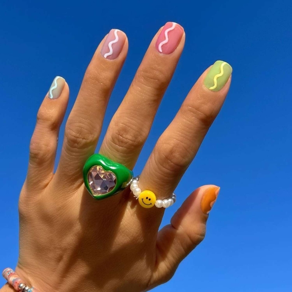 Short nails just make more sense for summer. From graphic designs to cool embellishments, find over a dozen short summer nail ideas for the months ahead here.