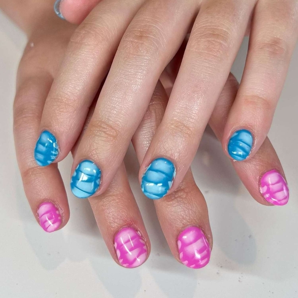 Short nails just make more sense for summer. From graphic designs to cool embellishments, find over a dozen short summer nail ideas for the months ahead here.