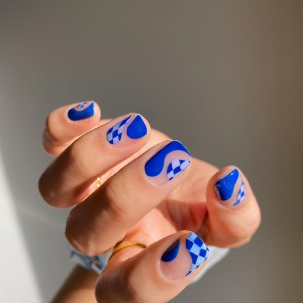 Short nails just make more sense for summer. From graphic designs to cool embellishments, find over a dozen short summer nail ideas for the months ahead here.