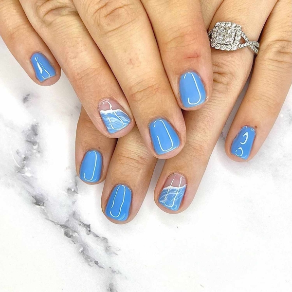 Short nails just make more sense for summer. From graphic designs to cool embellishments, find over a dozen short summer nail ideas for the months ahead here.