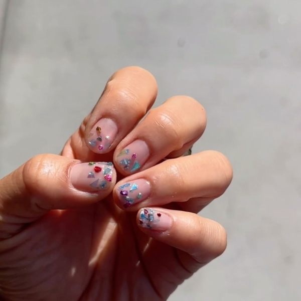 Short nails just make more sense for summer. From graphic designs to cool embellishments, find over a dozen short summer nail ideas for the months ahead here.