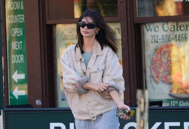 Emily Ratajkowski bared her abs with low-slung gray sweatpants that she wore with the top rolled down in New York City on May 31. She paired the Y2K-inspired look with a light mint crop top and a cream oversized bomber jacket.