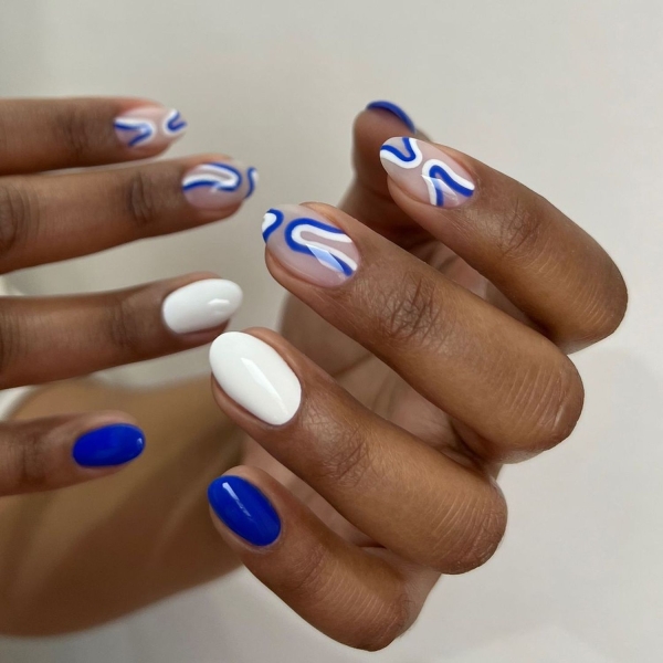 Blue nail designs are popular year-round for their fresh and cool vibe. Here, discover 20 blue nail designs to recreate at home with tips from pro nail artists.