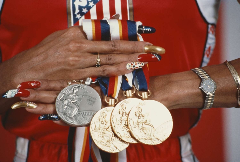 In a sea of uniforms, many Olympic athletes tap into beauty to express their personality and sense of style. From Florence Griffith-Joyner's nails to Naomi Osaka's bright red braids, here are our favorite Olympic beauty looks of all time.