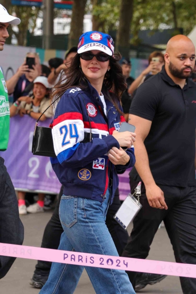 Kendall Jenner continued her Olympic style streak in a gold maxi skirt and a pair of sleek yet simple black flip-flops. See her full look, here.