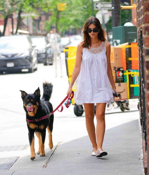 Look of the Day for August 20, 2024 features Emily Ratajkowski in a white lace-lined mini dress that looks like a nightgown and PVC Mary Jane ballet flats while walking her dog in New York City. Shop similar white nightgowns from Natori, Eileen West, and Petite Plume.