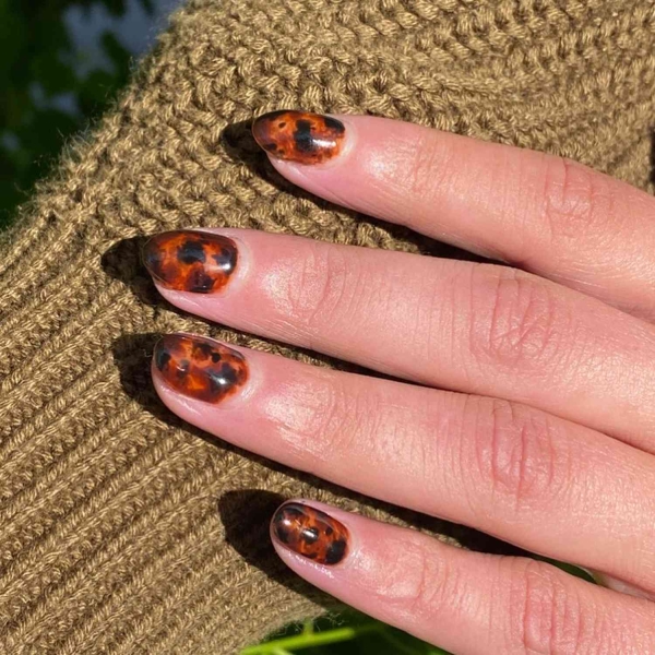 You don't need long nails to lean into the autumn season. Here, scroll through 20 short fall nail ideas that tap into everything we love about this time of year.