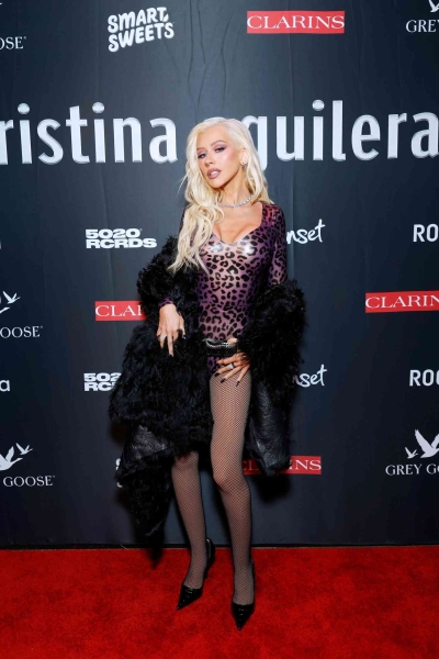 Christina Aguilera celebrated the 25th anniversary of her debut album with a Spotify Live album and a party in Los Angeles where she arrived wearing a leopard-print latex bodysuit. See her outfit, here.