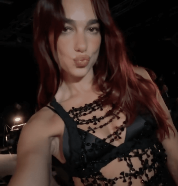 Dua Lipa wore a black beaded top with a satin bra in a post shared to her Instagram. See the look, here.