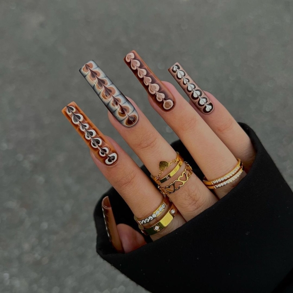 From graphic patterns to jewelry-like embellishments, here are 60 of the most stunning manicures for fall.