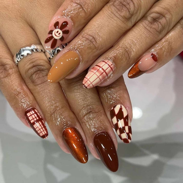 Pumpkin spice season has transcended the world of coffee to inspire fashion and beauty statements alike. Here, explore a bevy of pumpkin spice nail ideas for the most perfect fall mani.