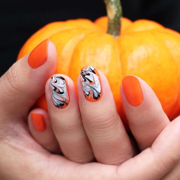 Pumpkin spice season has transcended the world of coffee to inspire fashion and beauty statements alike. Here, explore a bevy of pumpkin spice nail ideas for the most perfect fall mani.