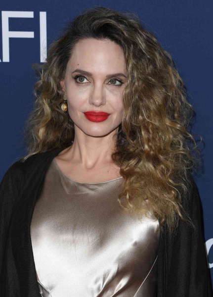 Angelina Jolie debuted big curls on the red carpet while attending the Los Angeles premiere of 'Maria' at the 2024 AFI Film Festival on Saturday, Oct. 26. See her hair transformation, here.