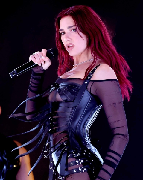 Dua Lipa shared photos of herself in a sexy, backless halter top and leather pants with hip cutouts. See her look, here.