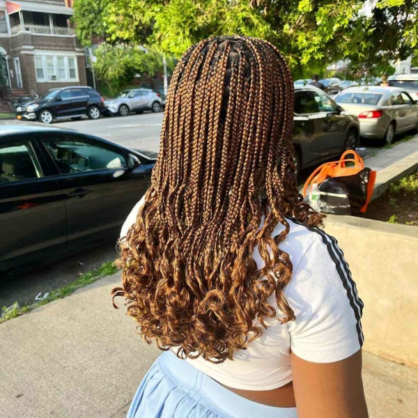 French curls are box braids done with silky, pre-curled braiding hair. Learn everything you need to know about the look, plus see 14 gorgeous French curl braids looks for inspiration.