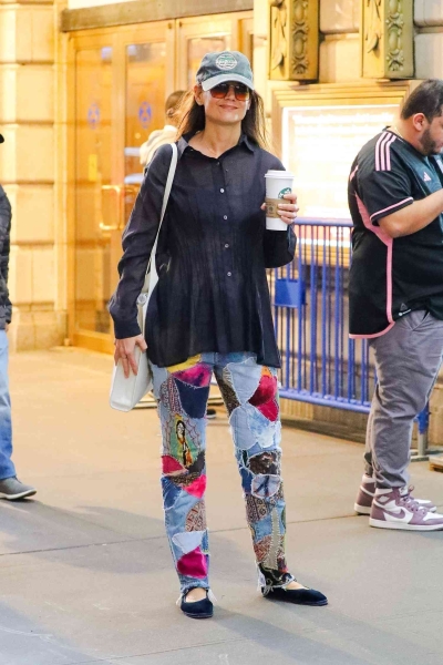 Katie Holmes leaned into the maximalist trend while wearing a pair of polarizing patchwork jeans with a psychedelic mod-podge design from Kapital on Friday, October 4.