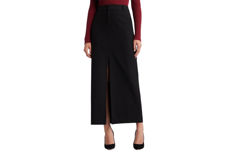 Look of the Day for October 16, 2024 features Zoe Saldaña in a black maxi column skirt, white button-down, and black mesh heels for a red carpet event.