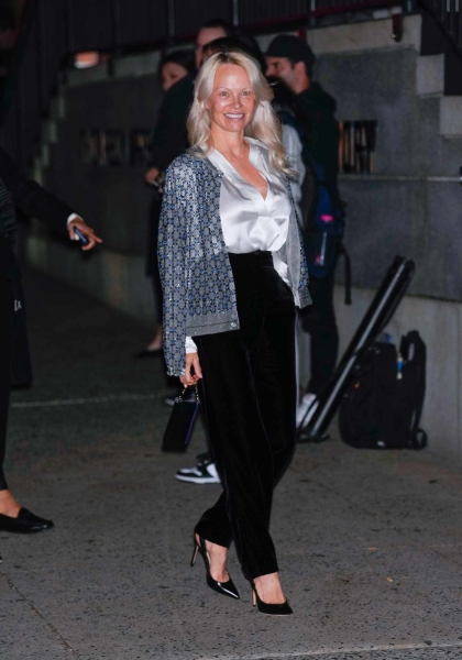 Look of the Day for October 17, 2024, features Pamela Anderson wearing a white silk blouse, sequined jacket dress, black velvet pants, and pointy-toe heels.