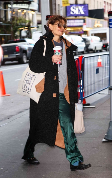 Katie Holmes paired a fuzzy black teddy coat and quiet luxury emerald green pants with chaotic clashing socks as she headed to the Barrymore theater for her performance of 'Our Town' on Saturday, November 23.