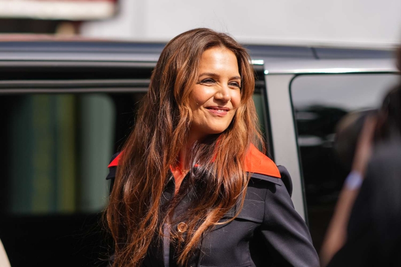 Katie Holmes rarely misses an opportunity to make a statement with her street style. Her latest outfit included the unusual pairing of a jewel-tone silk skirt and a pinstripe button-up. See photos of her look, here.