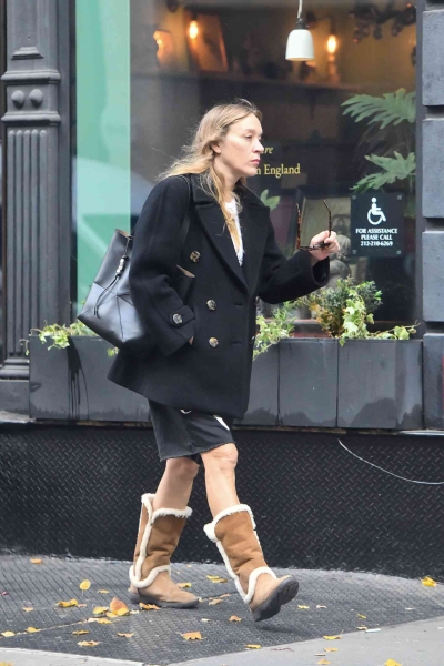 Look of the Day for November 6, 2024 features Chloë Sevigny in long Bermuda shorts, white tee, peacoat, and shearling lined suede boots that are a must-have for fall and winter 2024.