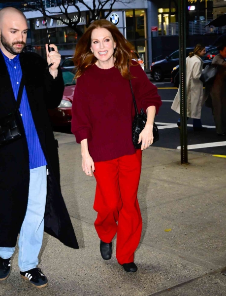 Look of the Day for December 11, 2024 features Julianne Moore in an all-red look, including a burgundy sweater, bright red pants, and glove-like black leather ballet flats while out in New York City.