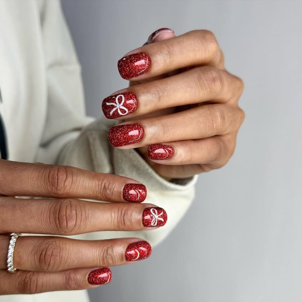 The color red is synonymous with Christmas and warm holiday cheer. Here, scroll through 18 red Christmas nail ideas for a festive touch this season.