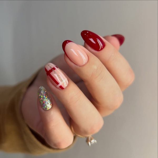 The color red is synonymous with Christmas and warm holiday cheer. Here, scroll through 18 red Christmas nail ideas for a festive touch this season.