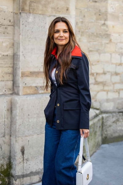 Katie Holmes wore her button-down backwards while attending Patou's fall 2025 runway show during Paris Fashion Week on Sunday, January 26. See her quirky look, here.