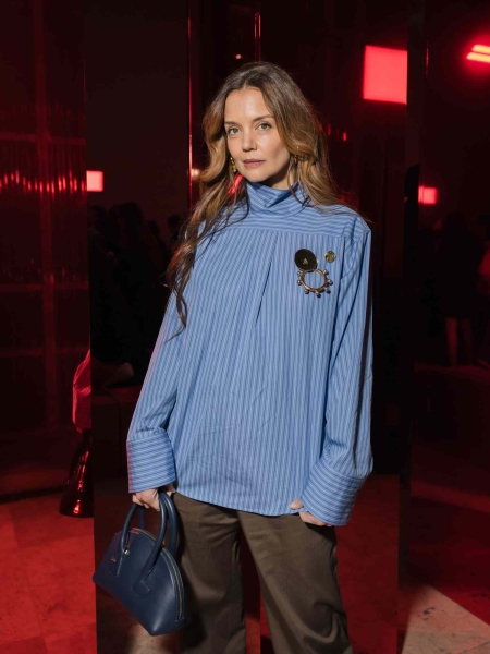 Katie Holmes wore her button-down backwards while attending Patou's fall 2025 runway show during Paris Fashion Week on Sunday, January 26. See her quirky look, here.